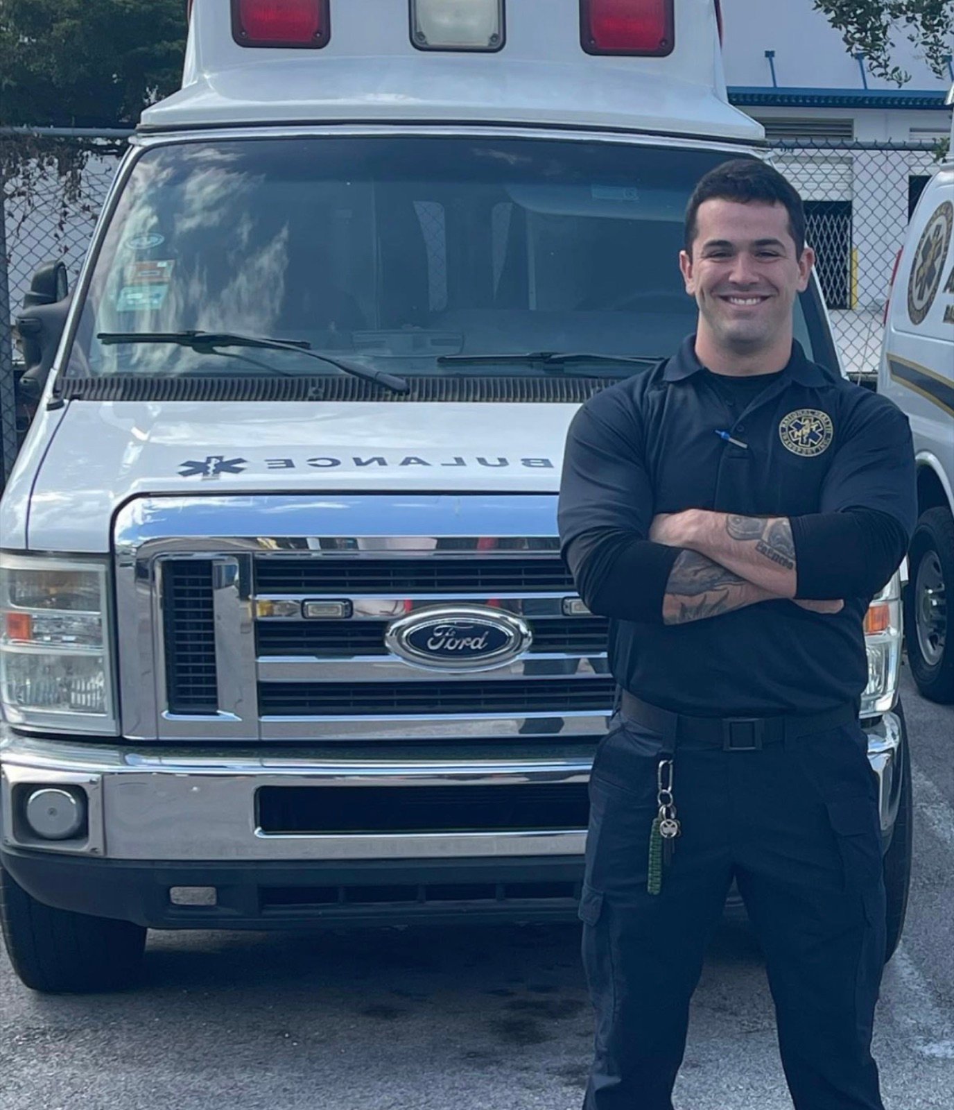 Javier Murillo in uniform standing in front of an ambulance